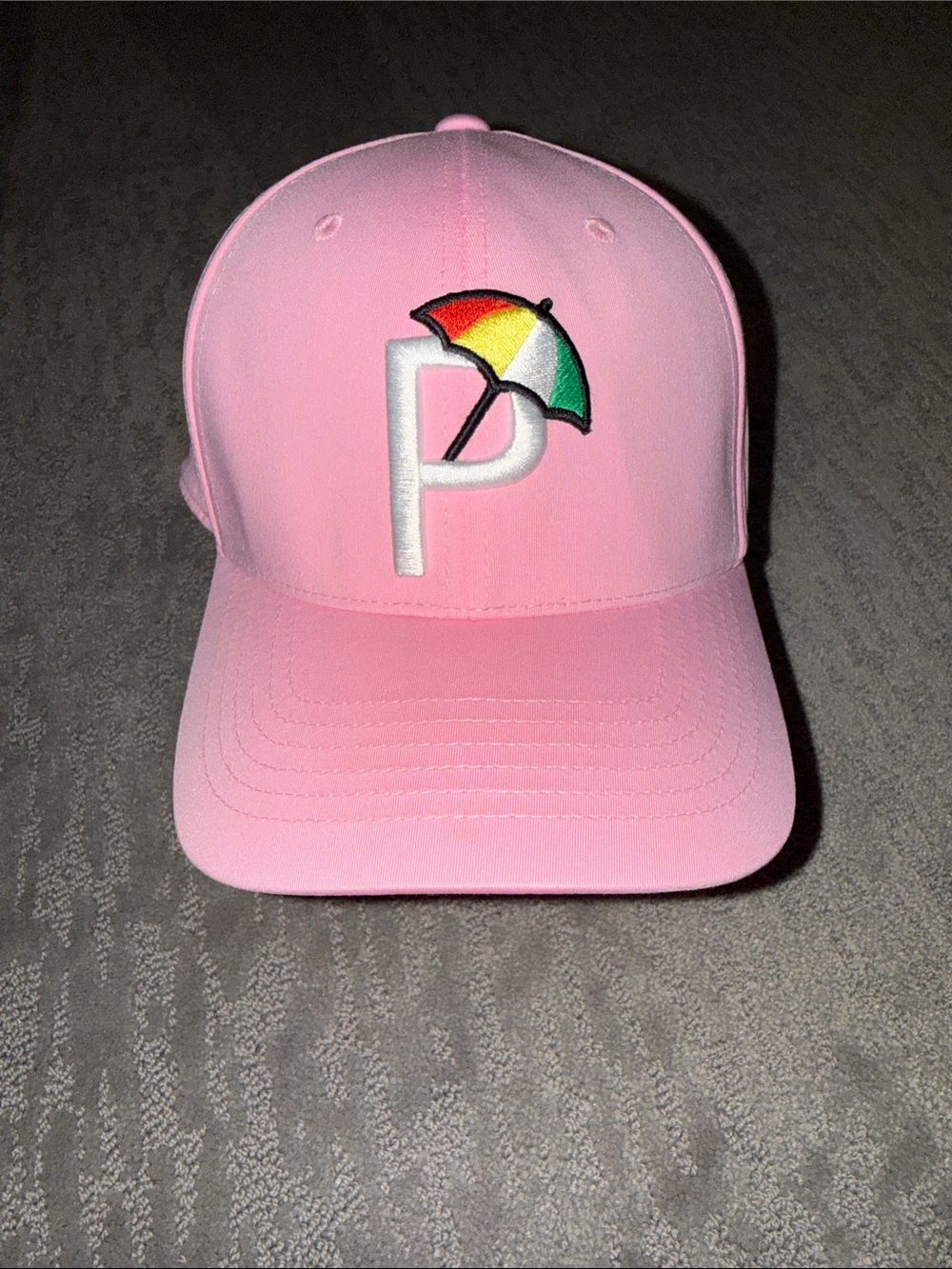 Puma pink golf hat with Arnold Palmer umbrella